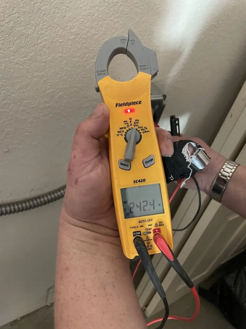 Voltage testing with clamp meter during Whole House Surge Protector in West Livingston